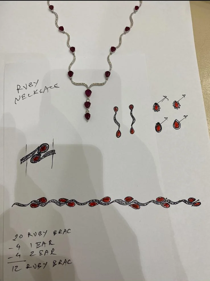 Hand sketches of a ruby necklace, earrings, ring and bracelet beside a photograph of the finished ruby necklace