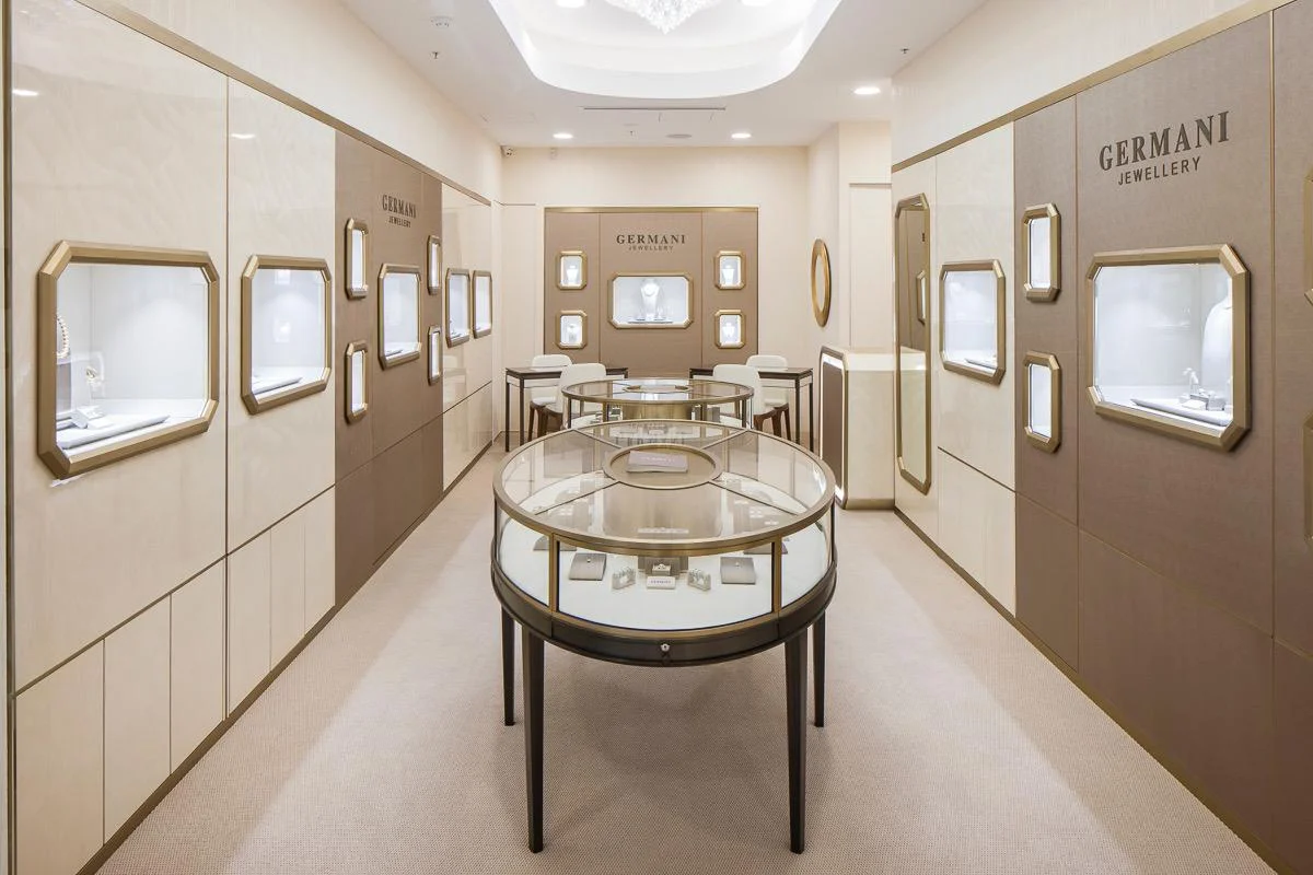 Inside a Germani boutique, with gold-framed display windows and a central showcase