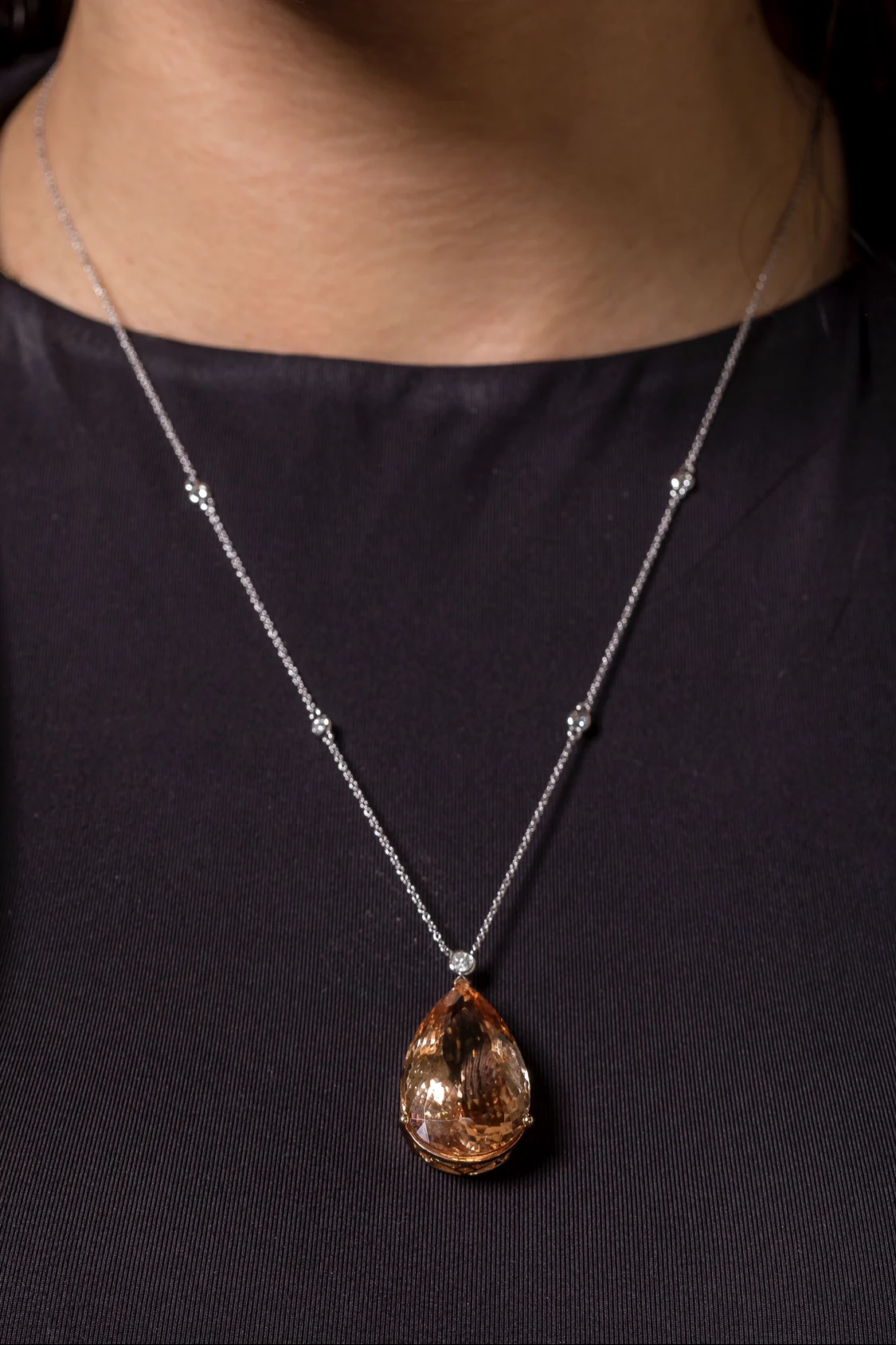 Morganite pendant on a diamond station chain, worn