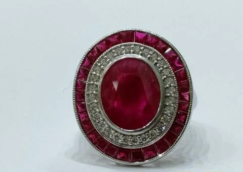 The finished oval ruby ring with diamond halo and calibré ruby frame