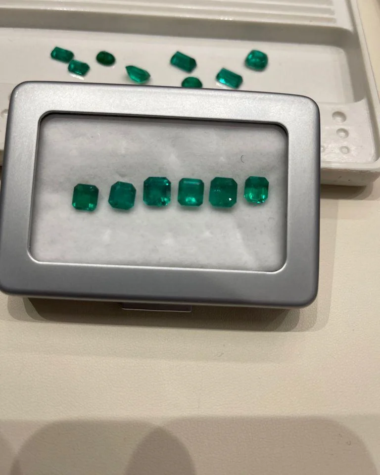 Loose natural emeralds laid out for selection