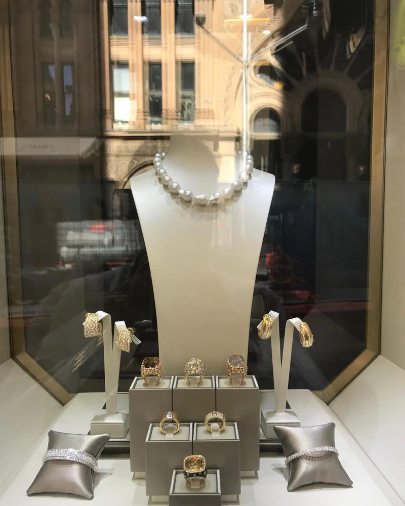 Germani window display with a baroque pearl strand, gold rings, earrings and diamond bangles