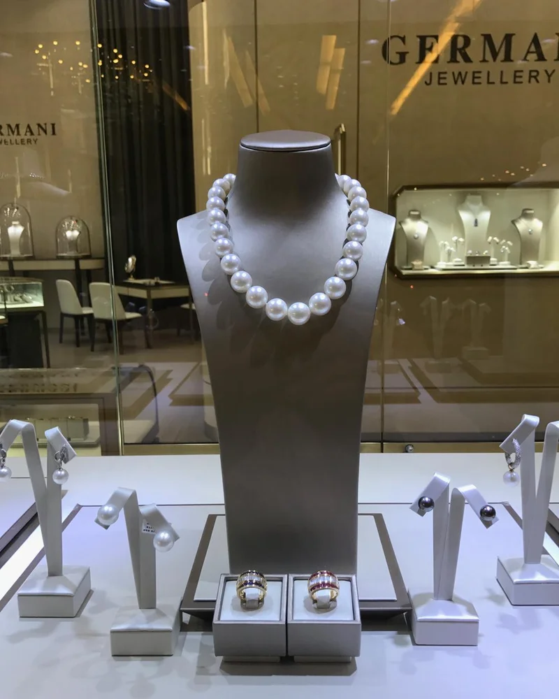 Germani window display with a South Sea pearl strand, pearl earrings and gem-set rings