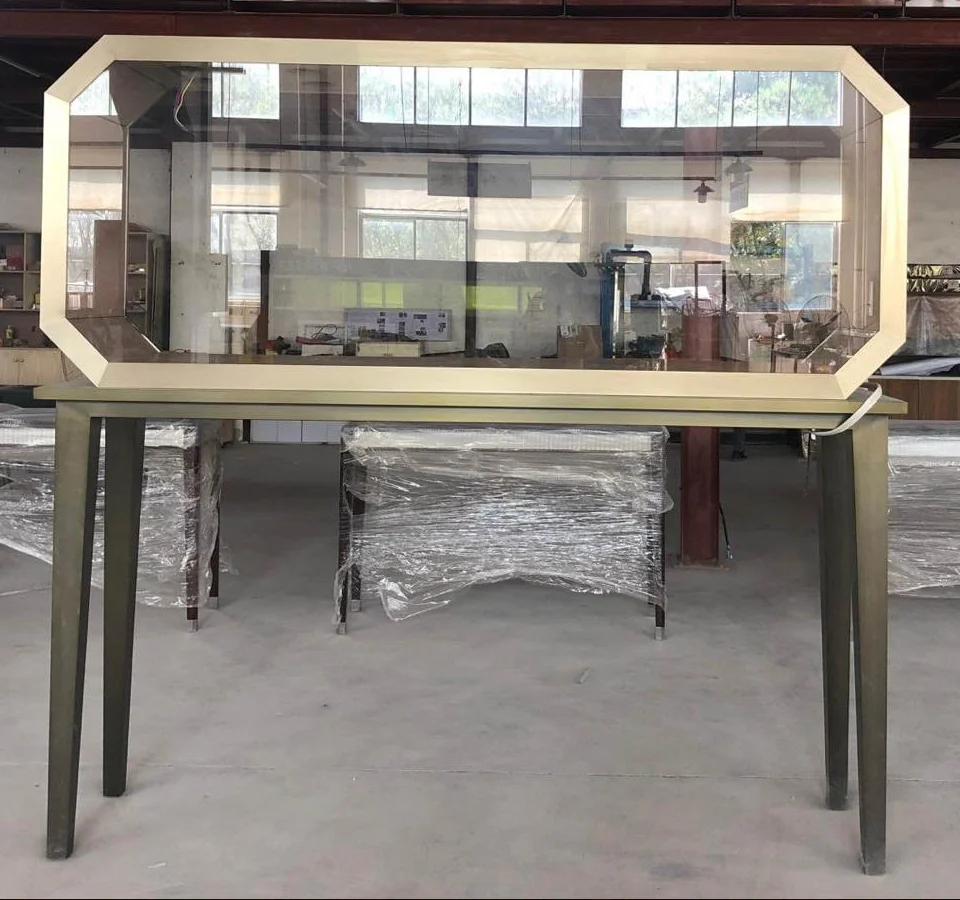 A gold-framed octagonal Germani window showcase in the workshop